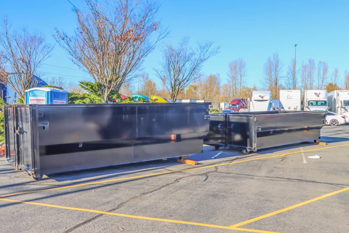Professional dumpster rental service with roll-off container on residential driveway in Guadalupe